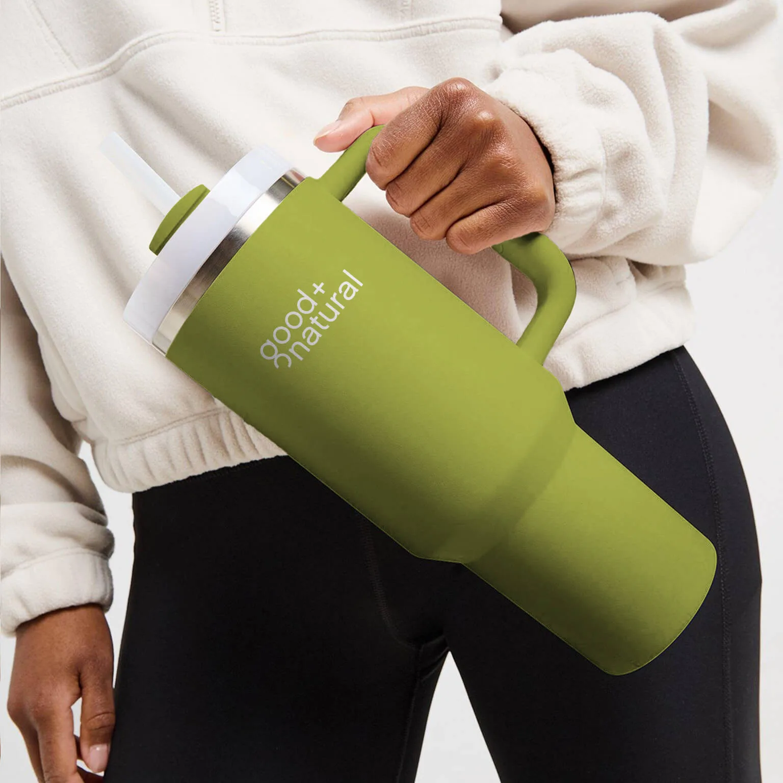 Good + Natural green water bottle held by a person – branding inspiration by Chez Koop, Steinbach Manitoba